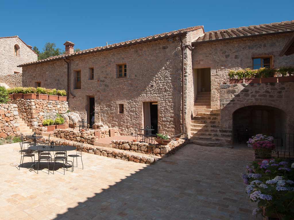 The stone courtyard of Relais La Costa near Monteriggioni